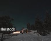 Timelapse shot of people gathering outside by the fire to look at beautiful natural phenomenon - polar lights. Rovaniemi, FinlandnLicense this clip: https://fillerstock.com/video/11869
