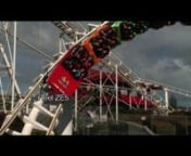 Big, fast roller coaster spirals by on steel tube track at amusement park.Other fast rides spin riders, fling them high in midair and drop them in little cars straight down to simulate free fall. nAll footage is available without watermarks and reel numbers.For thousands more archival or contemporary stock footage clips, contact Rick DeCroix at (212) 925-2547 or e-mail Rick at decroix@streamlinefilms.com or log on to www.streamlinefilms.com
