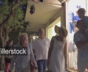Steadicam shot of big family with child happy with good shopping. They walking along the night street and carrying purchasesnLicense this clip: https://fillerstock.com/video/10734