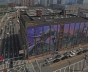 We paired up with local artist Distort at the Mecca &amp; Sons Trucking Co. for Jersey City’s largest mural project to date—16,000 sq ft to be exact. The site (580 Marin Blvd) is situated right at the mouth of the Holland Tunnel’s outbound lane which saw 15 million people pass by in 2016.n nThis one hundred year cold storage building sits 80’ tall by 200’ wide and still acts as a logistics facility today. To celebrate this historic building’s centennial, Distort has conceived a desi