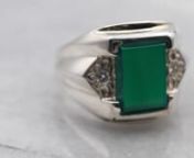 This sterling silver mounting has classic intricate engravings on the shoulders and around the bezel in the style popularized in the Mid-century! The timeless green onyx center is set with a polished rectangle cut which handsomely echoes the shape of the ring! Diamond accents add a bit of extra sparkle!nnMetal: Sterling SilvernGem: Green OnyxnGem Measurements: 7.2 x 10.0 mm, RectanglenAccents: 2 Diamonds totaling .08 Carats, SI in Clarity, G-H in ColornRing Size: 9nMarks: