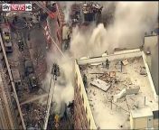 A local news helicopter shows the view from above a large building explosion in Harlem, New York City.