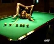 A rather bendy woman shows off her flexing talents on the pool table.